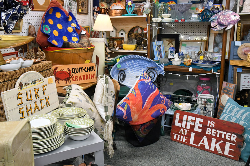 Antique signs and dining plate sets from one of the booths in our showroom